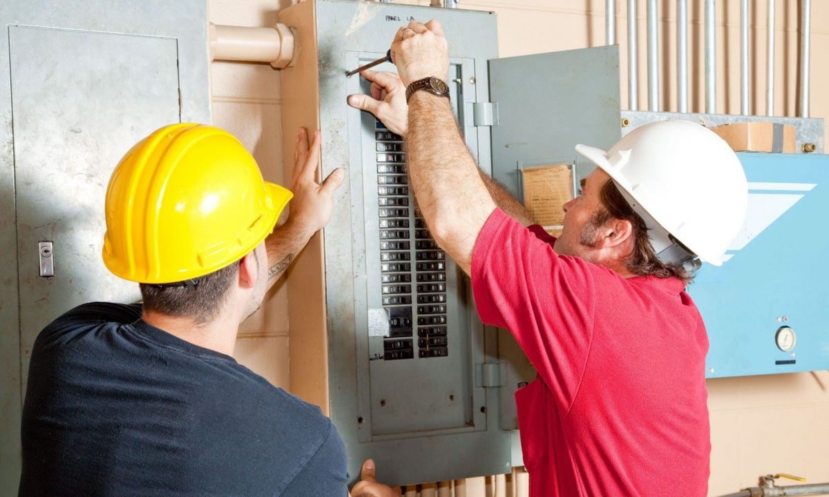 Electricians working repair breaker