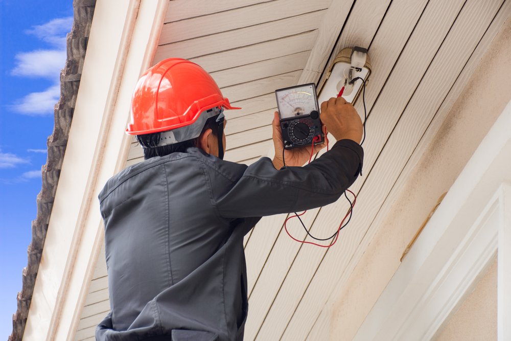 Electrician,Man,Hand,Holding,Multi,Meter,And,Checking,Voltage,At